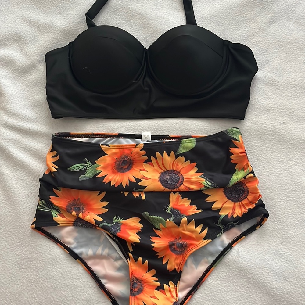 A nice summer bathing suit with a black top with orange flowers
